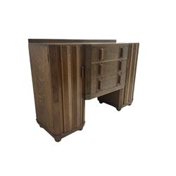 Early to mid-20th century Art Deco style oak sideboard, breakfront and fitted with three drawers and two cupboards, the cupboards enclosed by faceted door fronts