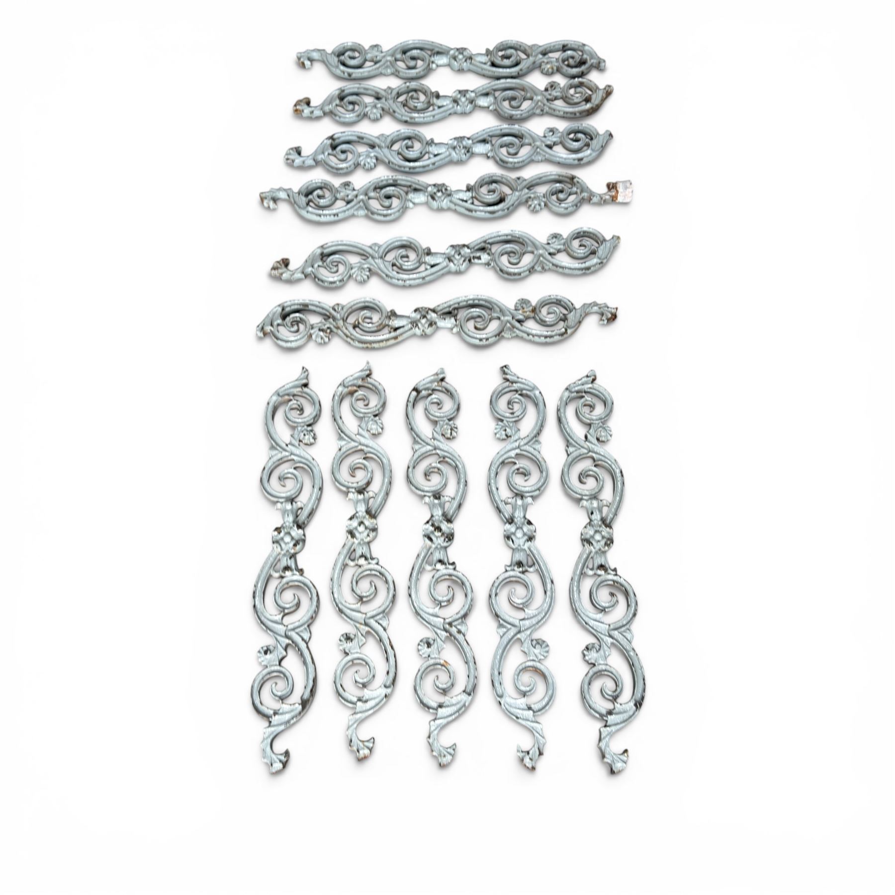 Set of eleven 19th century cast iron ornate stair or banister spindle supports, of scrolling form with scalloped decoration and flower-head motifs, in weathered duck-egg blue painted finish (11)