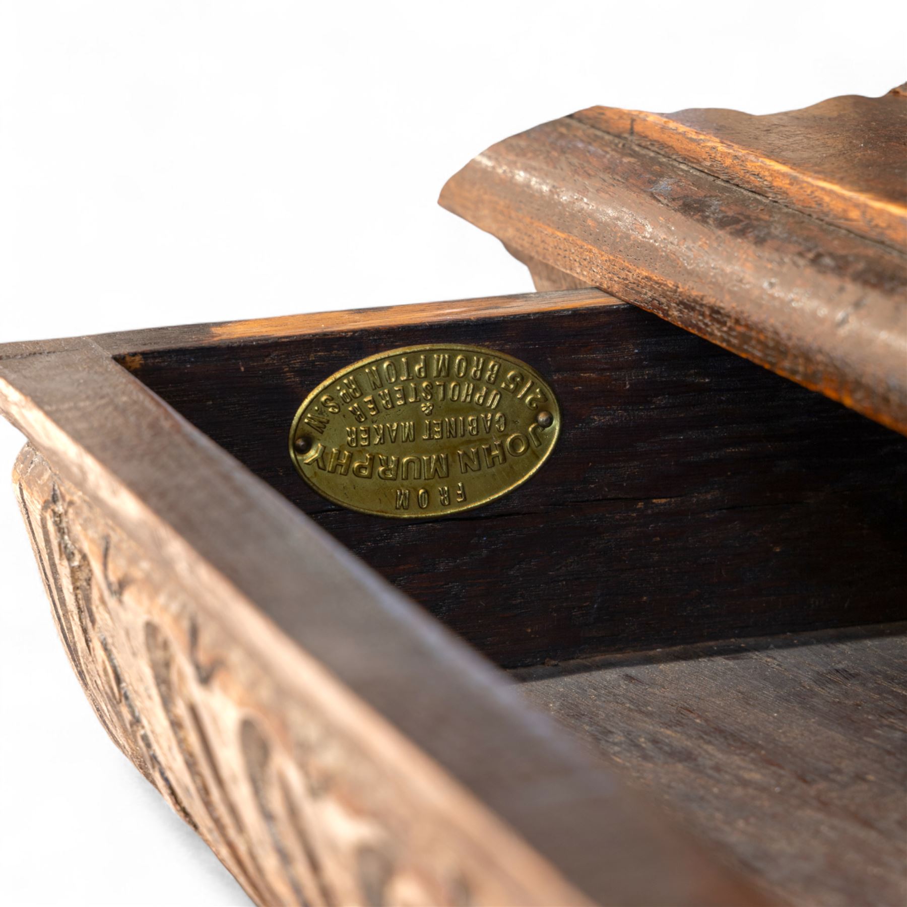 French carved oak cabinet in the Renaissance revival style, cornice carved with scrolling acanthus flanked by lion mask ring terminals, above glazed door with scroll supports over a carved panelled cupboard section with radiating shell motif and geometric quarter panels with foliate ornamentation, raised on a moulded plinth base 