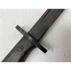 British Pattern 1907 bayonet with 43.5cm fullered steel blade; in leather scabbard with webbing frog L58cm overall; another Pattern 1907 bayonet lacking scabbard; and British Pattern 1888 Mk.I bayonet by Wilkinson London (no scabbard) (3)