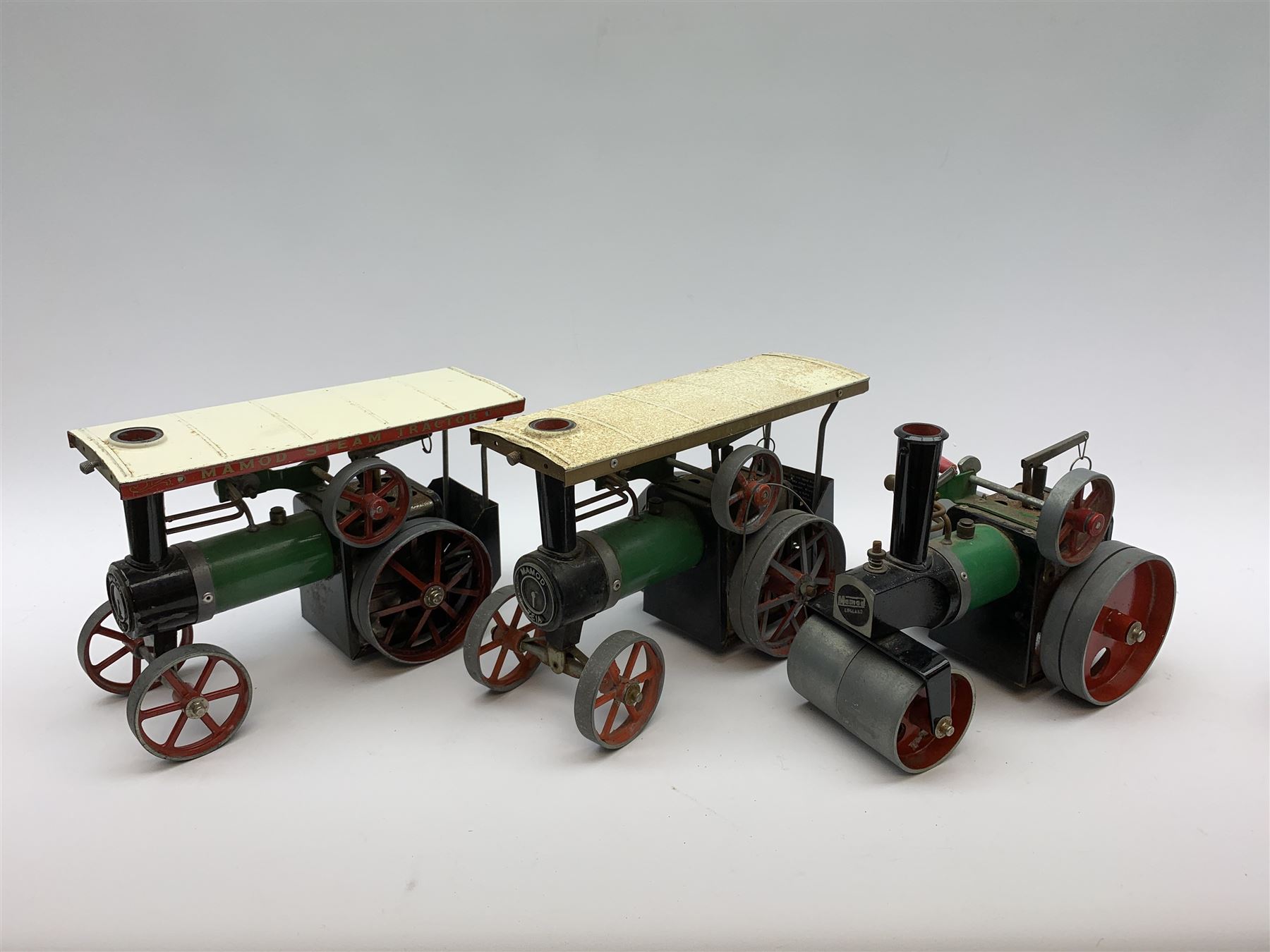 Two Mamod TE1A traction engines with steering rods; Mamod SR1 steam roller with steering rod; and Mamod lumber trailer, all unboxed (4)