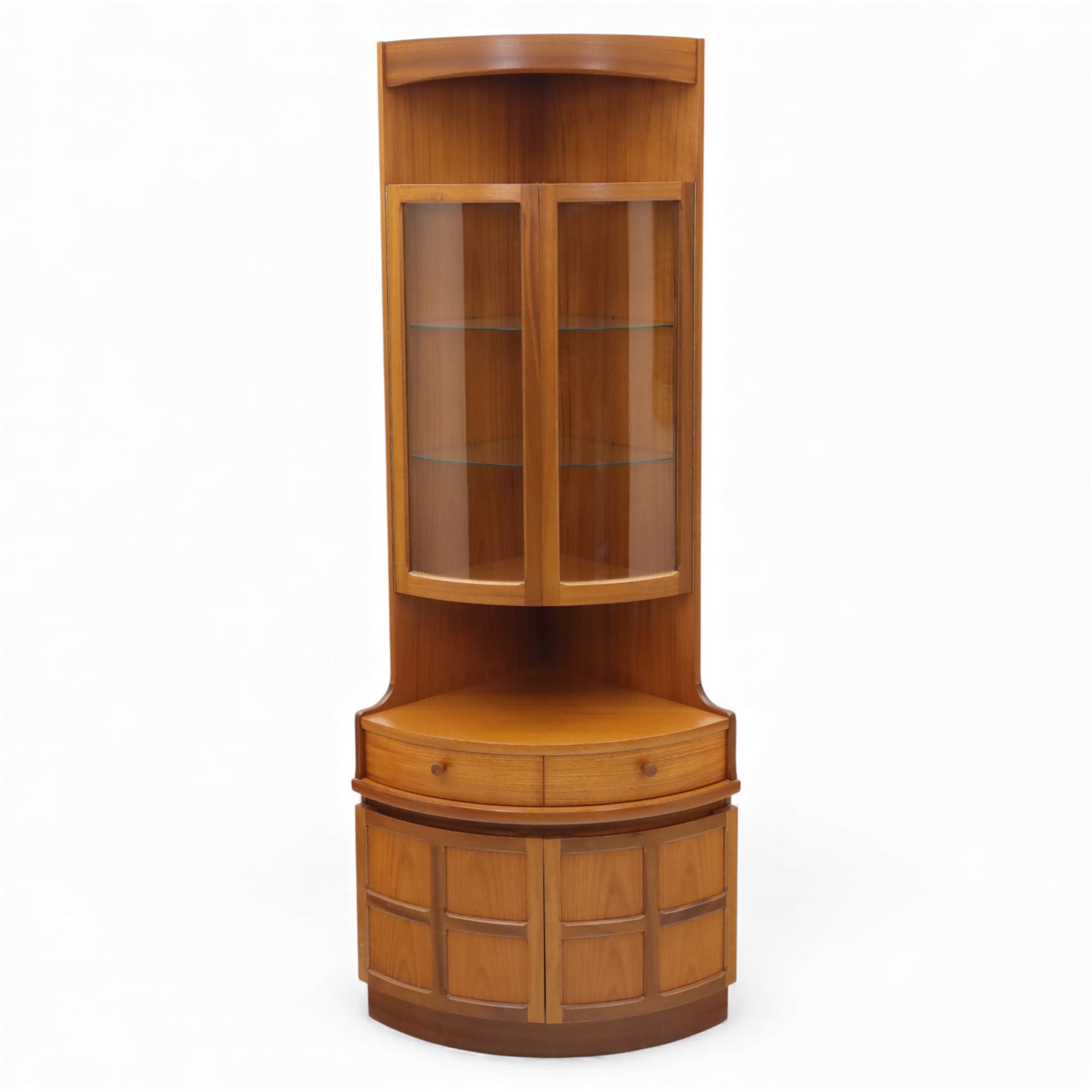 Nathan for Parker Knoll - corner cabinet, the upper section enclosed by two curved glazed doors with glass shelves, over a shaped base fitted with a single frieze drawer and panelled twin cupboard doors