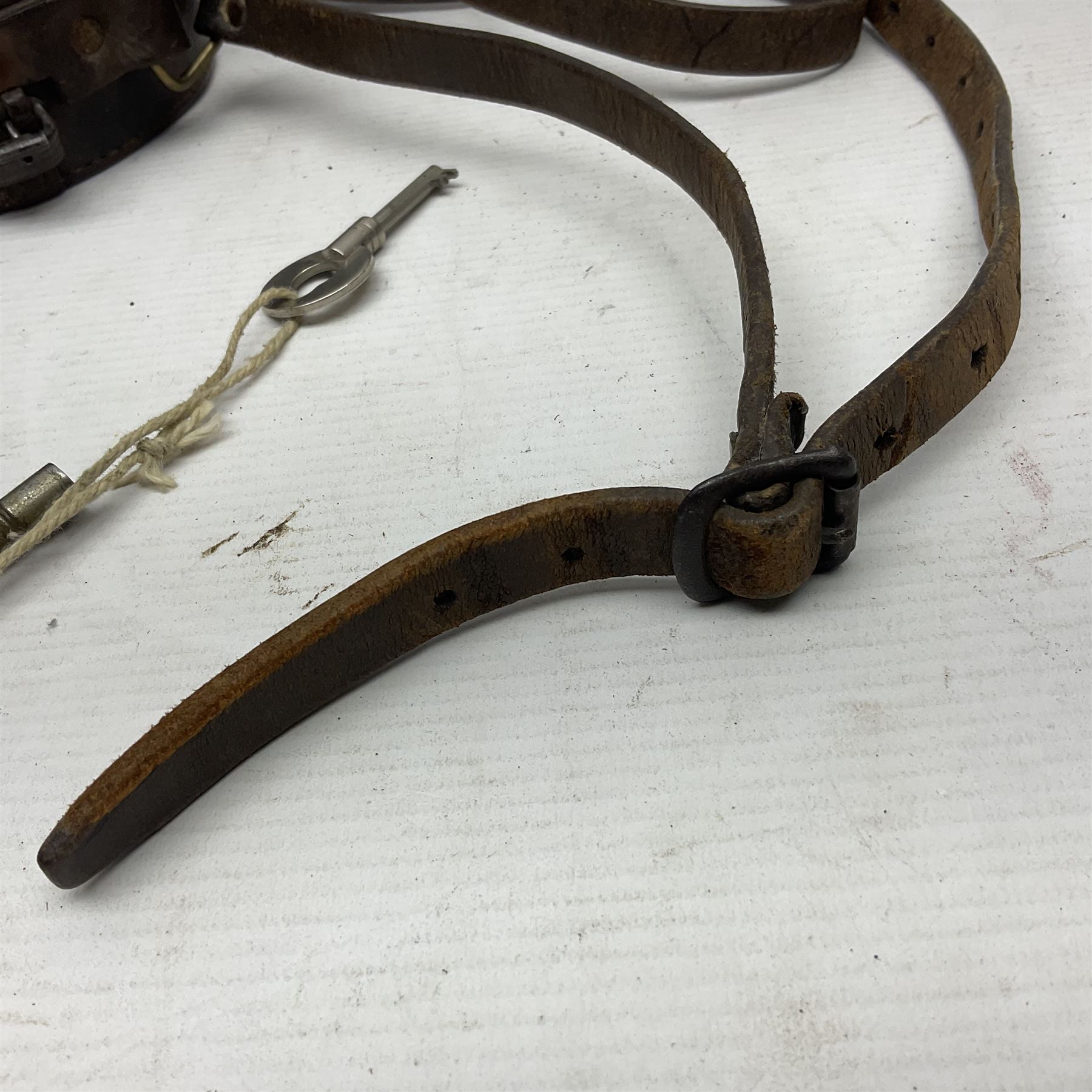 Metal cased drum shaped travelling clock with grey hammered finish, French clockwork movement and stitched leather outer case with shoulder strap; bears manuscript label 'Royal Armament Research and Development Establishment - serial no.09433' D13cm overall