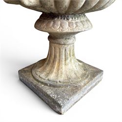 Pair of large cast stone garden urns, circular form with egg and dart border, tapering gadrooned bowl with cast handles and detail