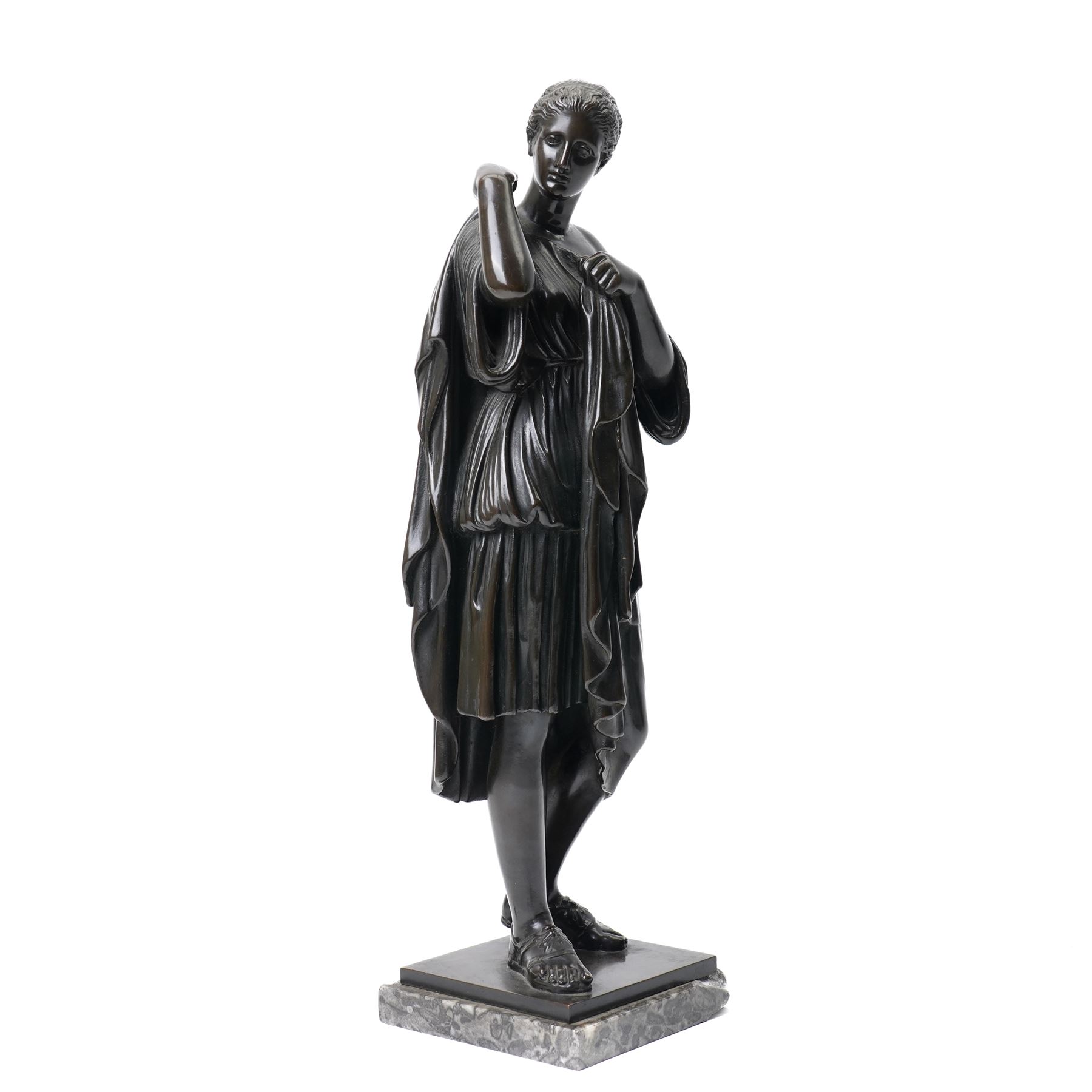After the Antique - Grand Tour patinated bronze figure of a Vestal Virgin, the maiden standing in contrapposto, draped in classical robes and pinning her chiton at the shoulder and chest, on a square marble base stamped to rear, circa 1900, W15cm H47cm