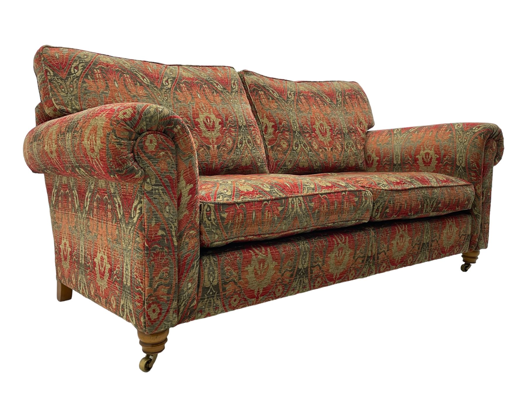 Duresta - 'Beaminster' grande two-seat sofa, traditional shape with rolled arms, upholstered in 'Althorp' russet and stone floral pattern fabric, on turned feet with brass castors
