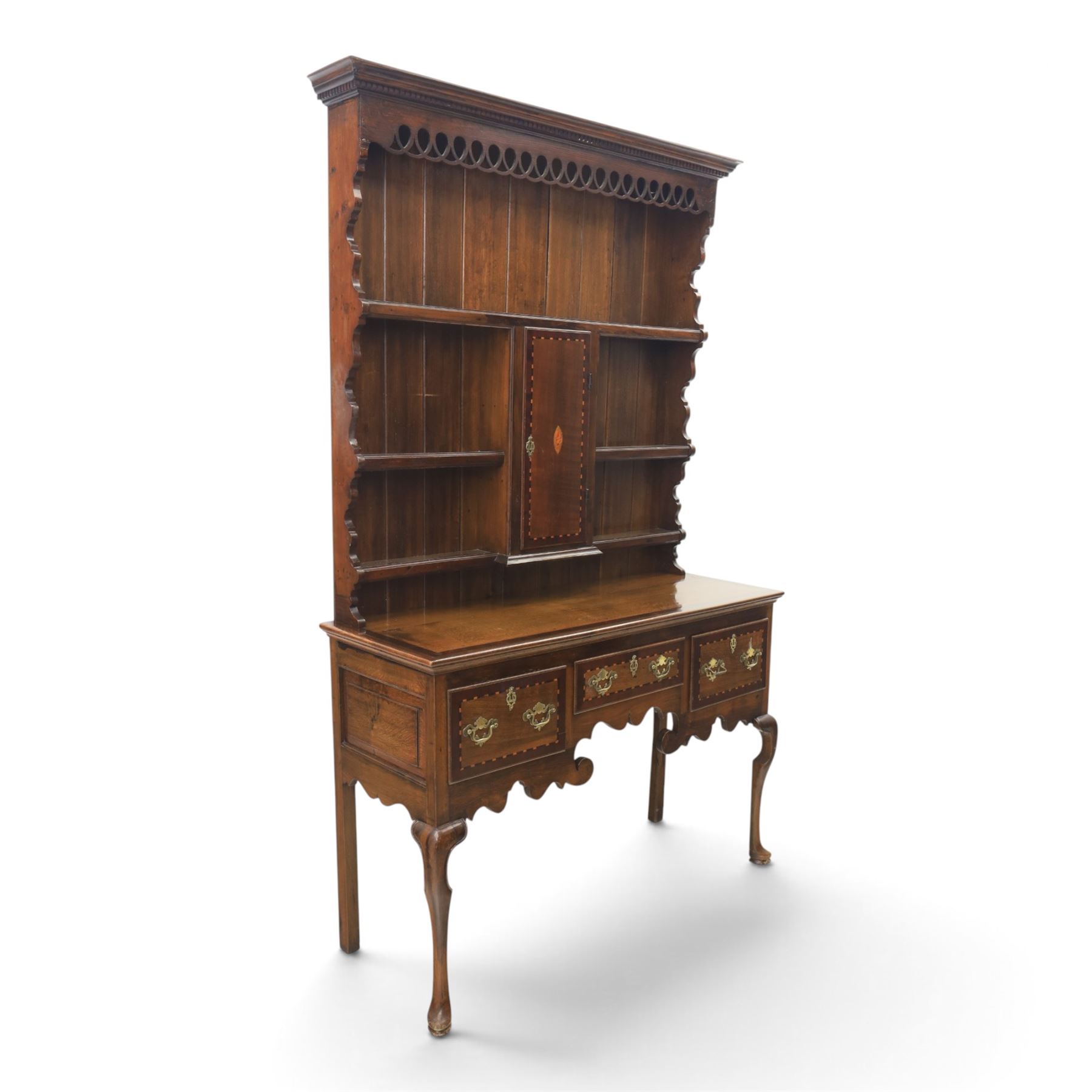Late 19th century inlaid oak dresser and plate rack, plate rack with projecting cornice and fretwork, with three shaped shelves for plates, central cupboard with inlaid shell and border, brass escutcheon and key, the lower section with crossabanded top, above three drawers with brass handles and inlaid border, shaped apron raised on cabriole supports 
