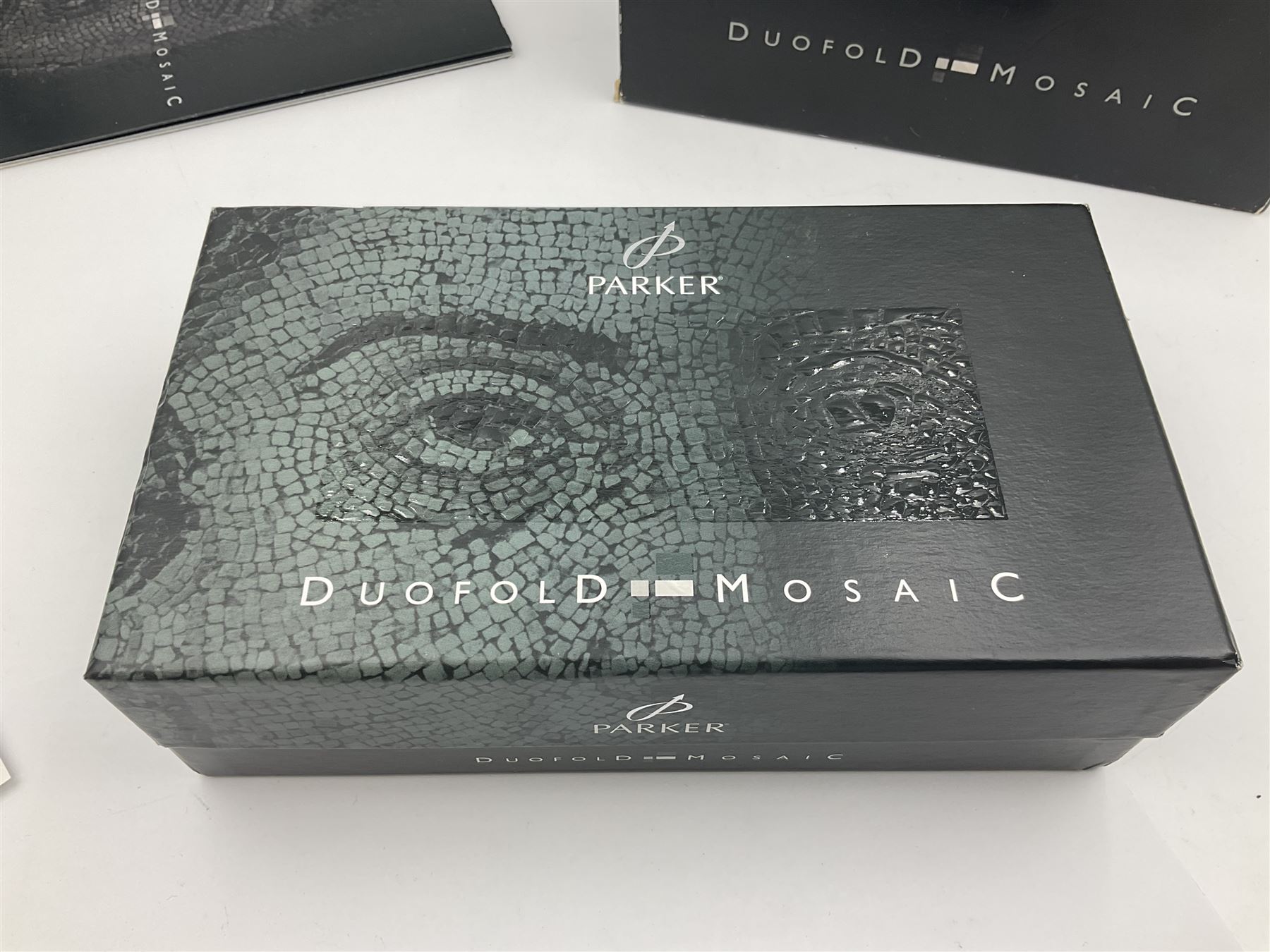 Parker Duofold Mosaic special edition fountain pen, issued in 2002, the black, pearl cream and grey cap barrel and cap with double bands and arrow clip, with gold nib stamped 18K 750, housed in original box and outer card packaging with booklet and wiping cloth