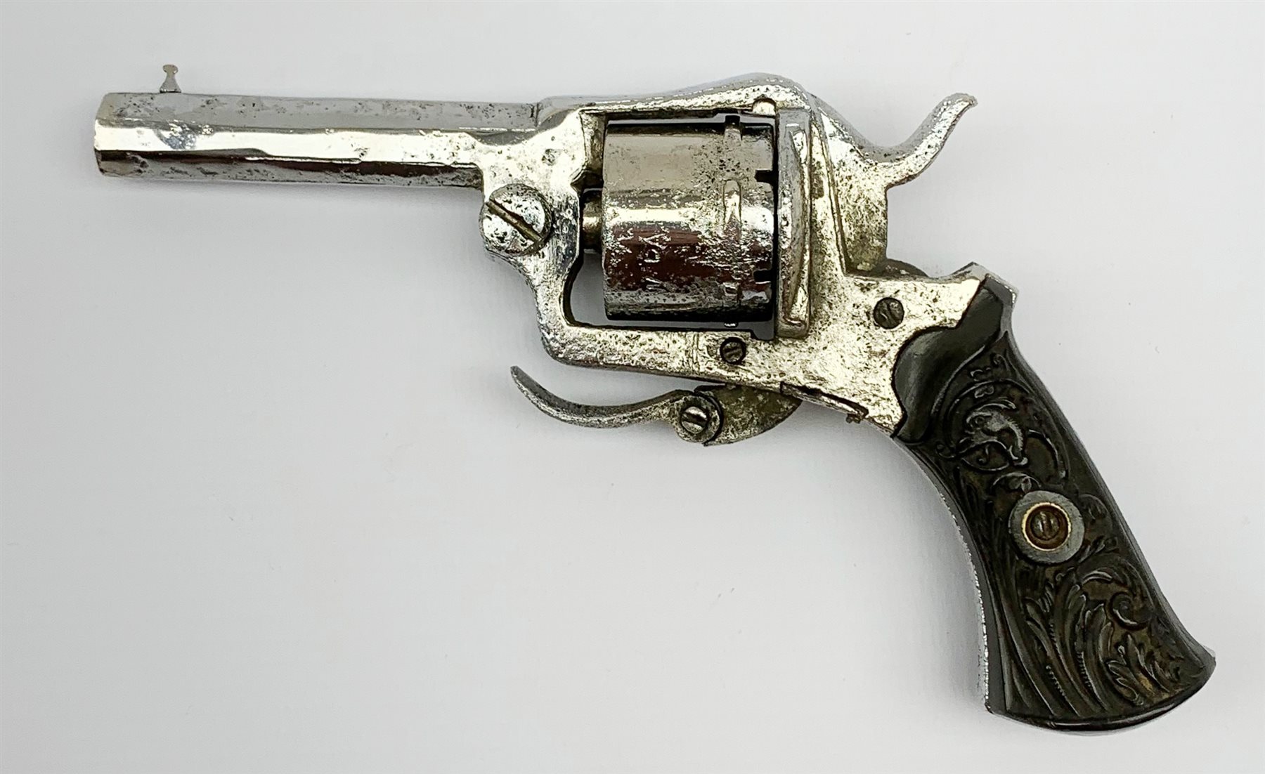 19th century plated Belgian 7mm pin-fire revolver, the six-shot cylinder inscribed 'The Young Lion 1881 New Pattern', with folding trigger and carved walnut split stock, barrel length 7.5cm, overall length 18.5cm