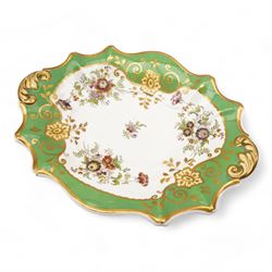 Large early 19th century Derby porcelain dessert basket, of rectangular twin-handled form, with cobalt blue and gilt decoration, painted marks beneath, L29cm together with a 19th century porcelain dessert service, decorated with floral sprays within a green and gilt border, comprising eight plates and three serving dishes, pattern no. 701/1