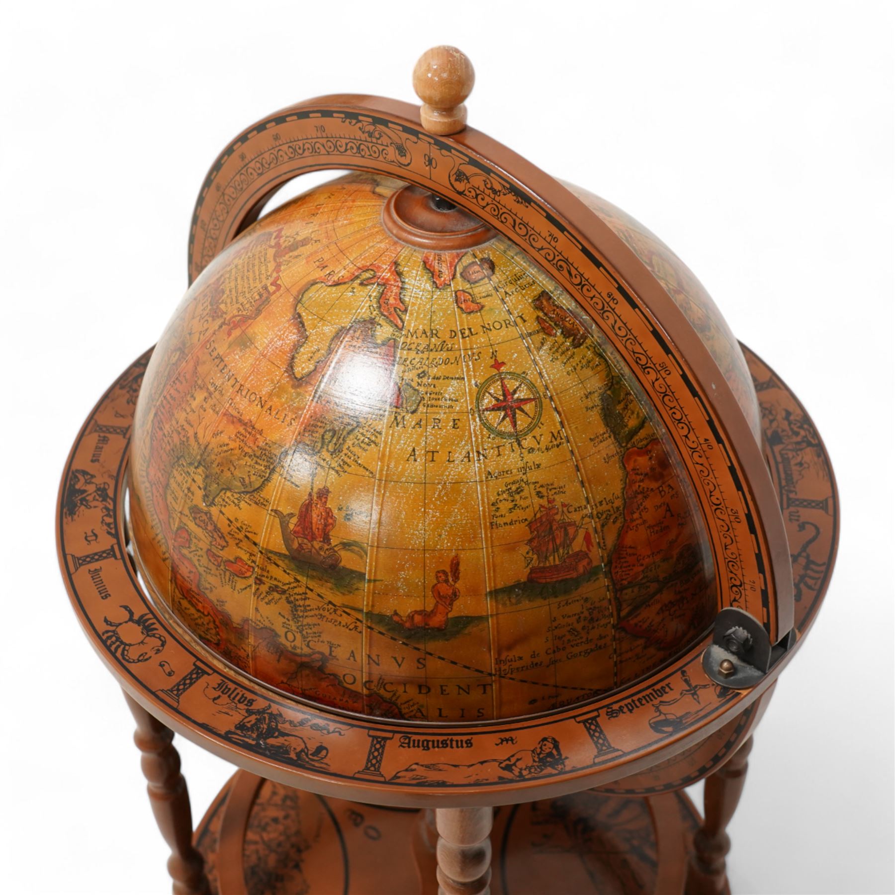 Late 20th century drinks globe, hinged lid enclosing drinks holders, on turned supports
