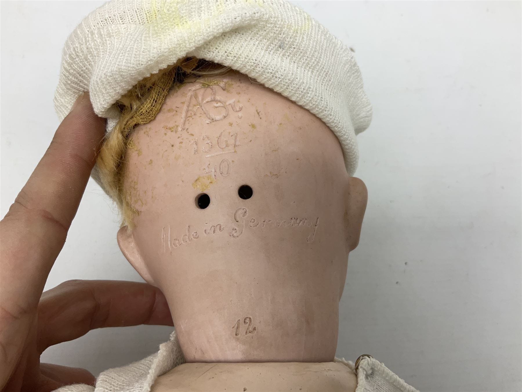 Carl Harmus Germany bisque head doll with applied hair, sleeping eyes, open mouth with teeth and composition body with jointed limbs; marked 'Harmus 313.4/0 Germany' H38cm; and Alt, Beck & Gottschalk Germany bisque head doll with applied hair, fixed eyes, open mouth with tongue and composition body with jointed limbs H44cm (2)