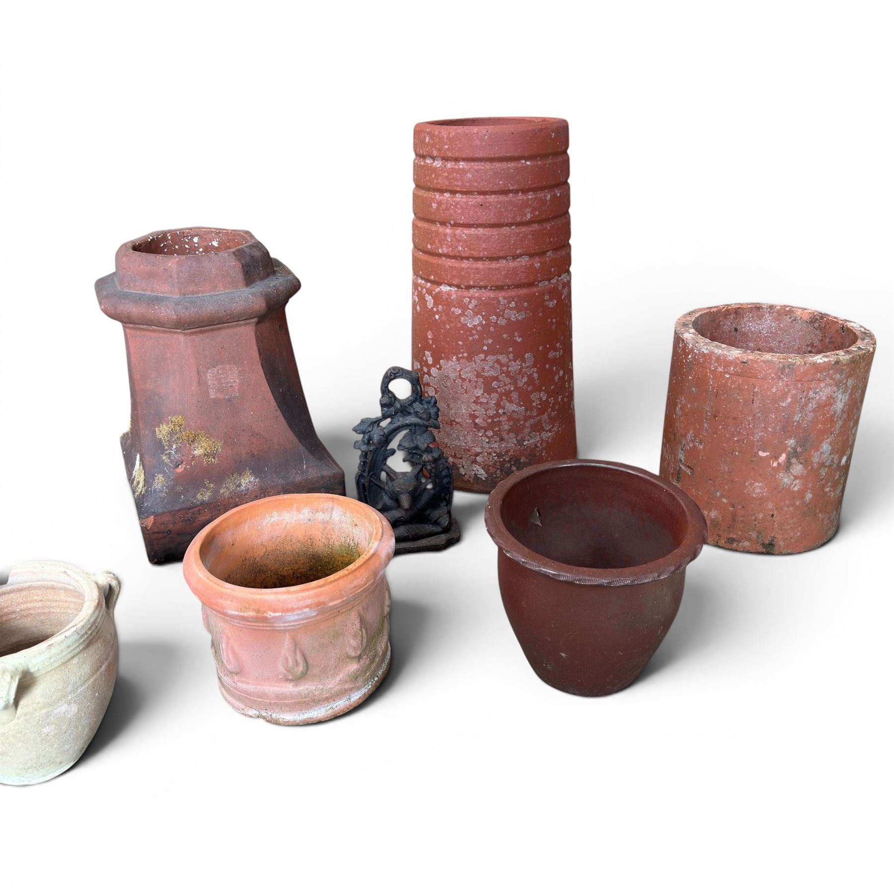 Two Victorian terracotta octagonal squat chimney pots, three other pots, terracotta planter, three small planters, cast iron fox door stop and a cherub wall pocket