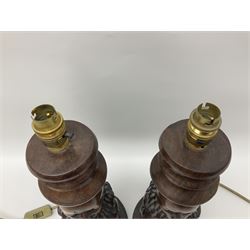 Pair of 20th century carved wood table lamp with African busts and figures, together with a carved wooden figure and soapstone figure, lamps H44cm