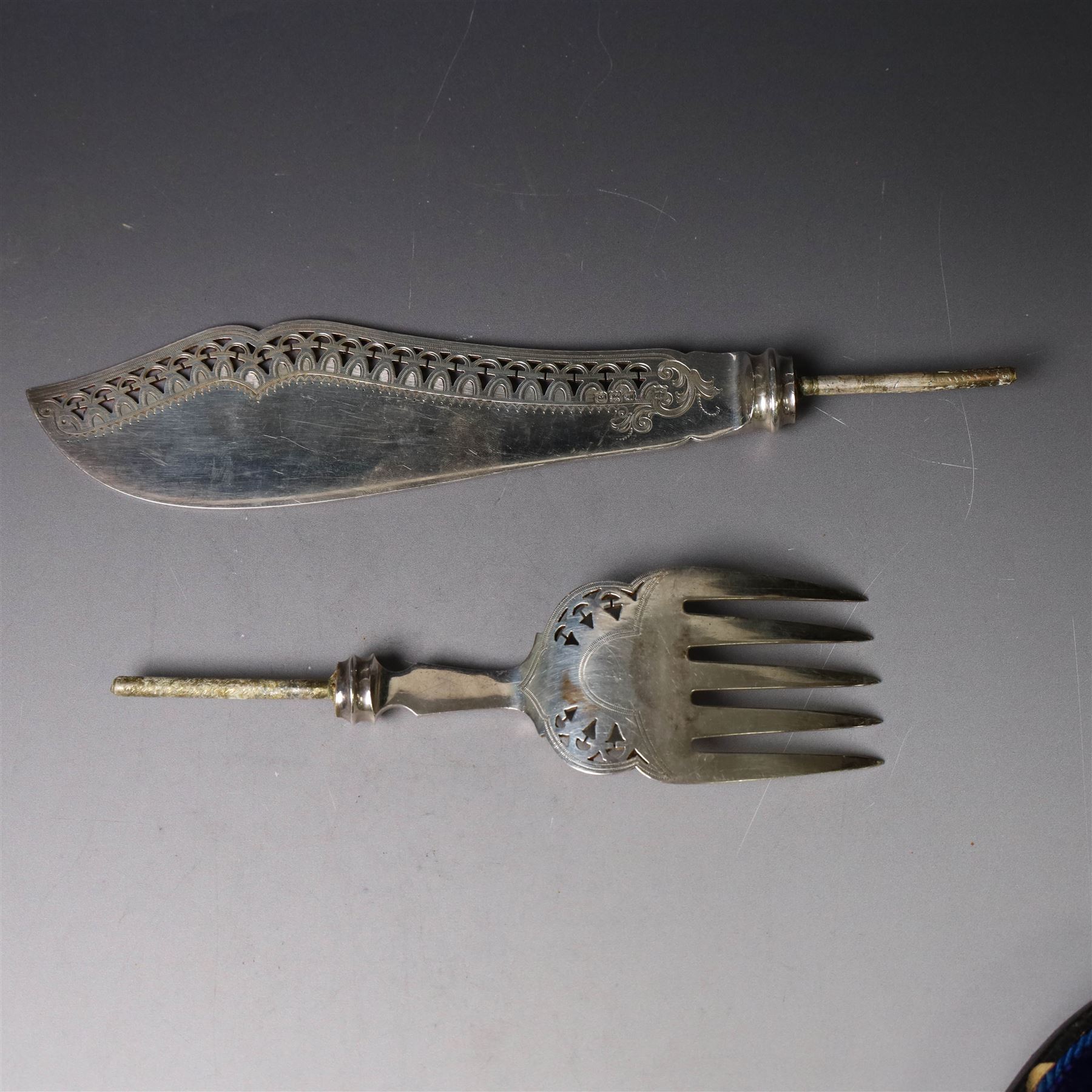 Pair of late Victorian silver fish servers, each with pierced and engraved geometric decoration, hallmarked Goldsmiths & Silversmiths Co, London 1896, handles removed, contained within fitted case