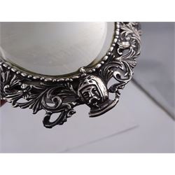 Continental silver miniature dressing table/wall mirror, of oval form with bevelled mirror plate, surrounded by a bead and dart rim, with pierced scrolling floral border with a standing cavalier to either side and the bust of a cavalier to the base, H17.7cm
