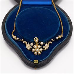 Edwardian gold pearl floral necklace, the openwork stylised floral and scroll mount set with split and seed pearls, to a rope twist chain necklace, in a tooled leather and blue velvet box
