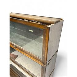 Globe Wernicke - early 20th century oak four-tier stacking library bookcase, four glazed sections enclosed by hinged and sliding doors