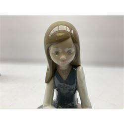 Four Lladro figures, comprising Afternoon Promenade no 7636, Nostalgia no 5071, both with original boxes, Girl with Lilies no 4972 and Madonna no 4534, largest example H27cm