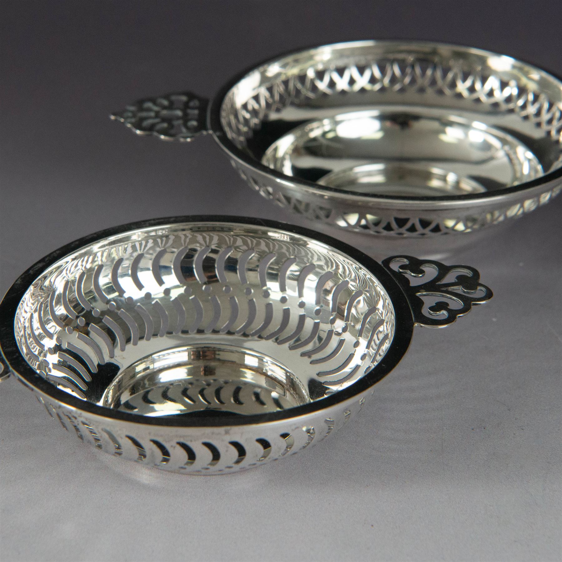 Two pairs of Victorian silver bon bon dishes, modelled as quaiches with pierced sides and twin handles, the larger pair hallmarked Synyer & Beddoes, Birmingham 1913 or 1938, the smaller pair hallmarked Birmingham 1913 or 1938, maker's marks worn and indistinct, largest D9cm