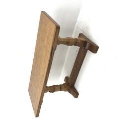 'Mouseman' oak coffee table, rectangular adzed top, two octagonal pillar supports on sledge feet connected by floor stretcher, by Robert Thompson of Kilburn, 91cm x 38cm, H44cm