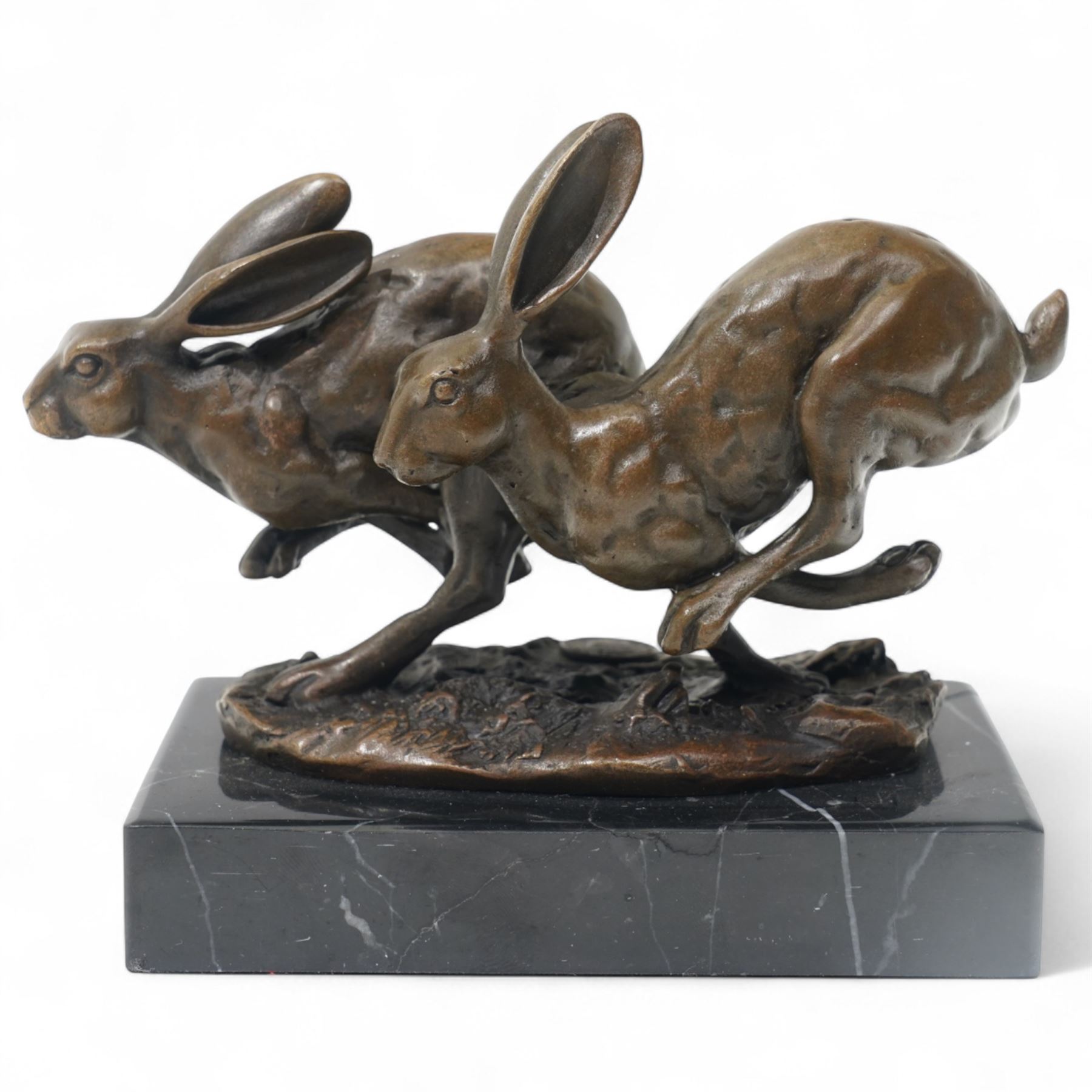 Bronze figure group modelled as two hares in chase, signed Nick and on marble base H12cm