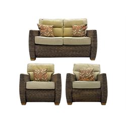 Contemporary two seat rattan conservatory sofa with loose cushions, and pair of matching armchairs, with upholstered seat and back cushions in a beige fabric, curved arms and front complete with scatter cushions 

Chairs (H 92cm, W 75cm, D 84cm)
Sofa (H 92cm, W 130cm, D 84cm)