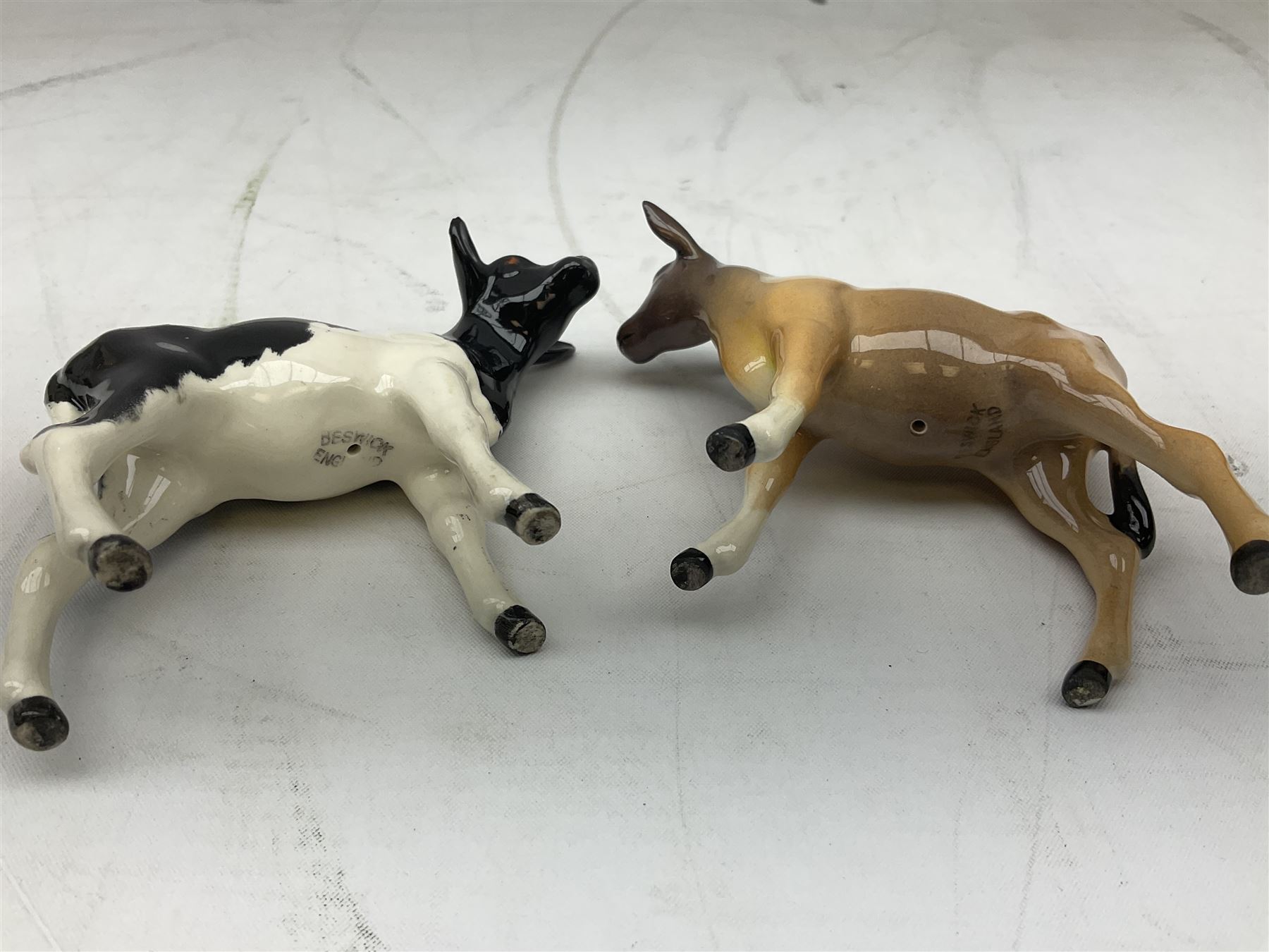Seven Beswick cow figures, to include Friesian bull Ch. ''Coddington Hilt Bar'' no. 1439a, Friesian cow Ch. 'Claybury Leegwater' no. 1362a and Friesian calf no. 1249C, Aberdeen Angus calf 1827a, Jersey cow no. 1345 etc, all with printed mark beneath  