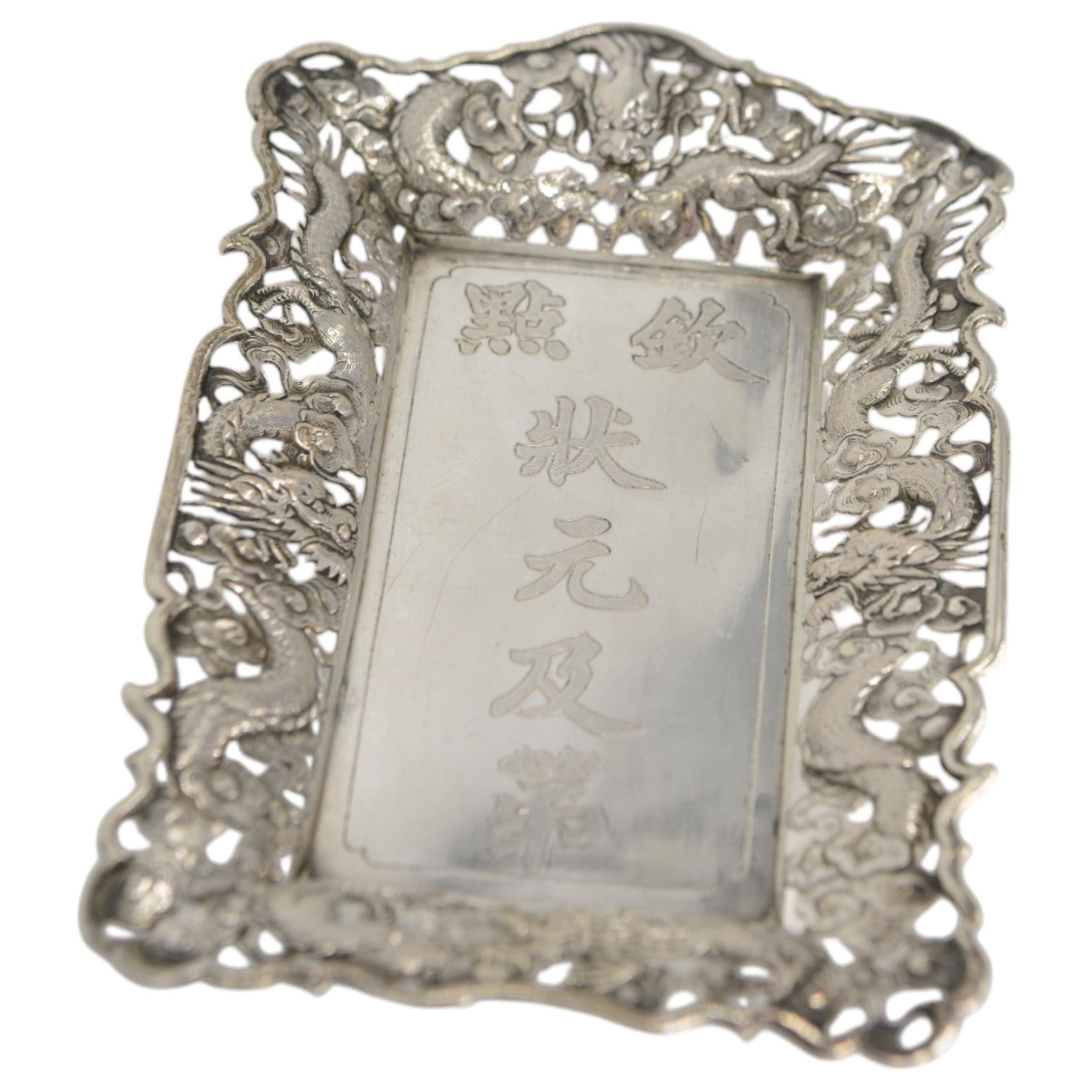 Chinese export pin tray, of rectangular form, the pierced sides embossed with dragons amongst flowers, stamped with character marks and maker's mark for Hungchong & Co, L13cm 