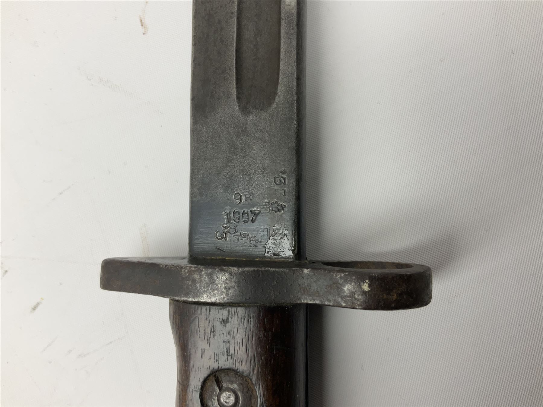 British Enfield 1907 model SMLE bayonet, with 43cm fullered steel blade and metal mounted leather scabbard L58cm overall; and Schmidt-Rubin Model 1918 bayonet the 30cm steel blade marked Elsener Schwyz No.579722; in steel scabbard with leather frog marked G. Bertolini Sellaio Vira/G.Tic 79 L45cm overall (2)