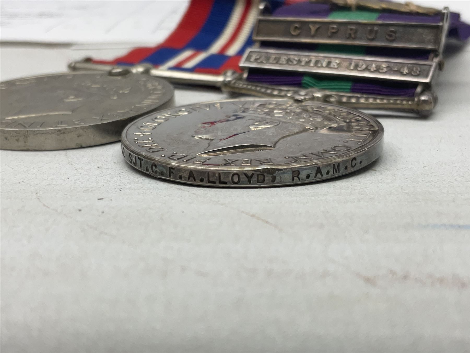 George VI General Service Medal with two clasps for Palestine 1945-48 and Cyprus and MID oak leaf awarded to 14887162 Sjt. C.F.A. Lloyd R.A.M.C. together with WW2 War Medal 1939-1945; both with ribbons; and quantity of photocopied research material including Army Records and London Gazette
