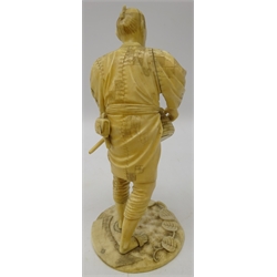  Japanese Meiji period carved ivory figure of a Farmer dressed in a robe, holding a basket and stick, signature to base, H21cm   