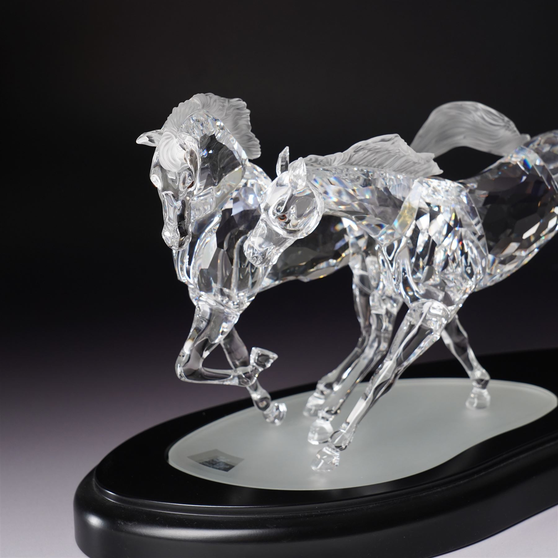 Swarovski, Wild Horses, modelled as two galloping horses upon a wooden plinth, limited edition 3915/10000, with certificate and case, H20cm