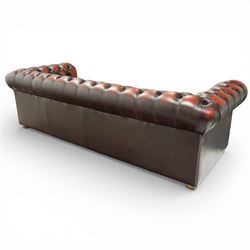 Late 20th century four seat Chesterfield sofa, upholstered in deep buttoned brown leather, with rolled arms, buttoned back and seat, studded detailing and squat feet