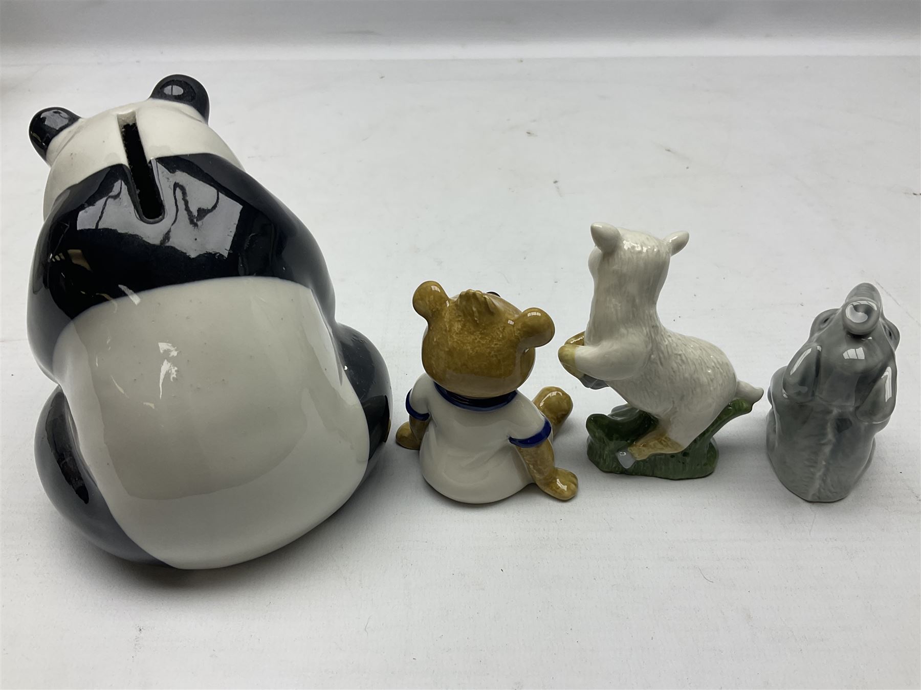 Nine Wade Collectables figures, comprising six Myths and Legends; King Canute, Mermaid, St George, Cornish Tin Mine Pixie, Puck and Green man, together with Lamb, Elephant and bear, a Wade Panda money box and two boxes of Wade Christmas Crackers