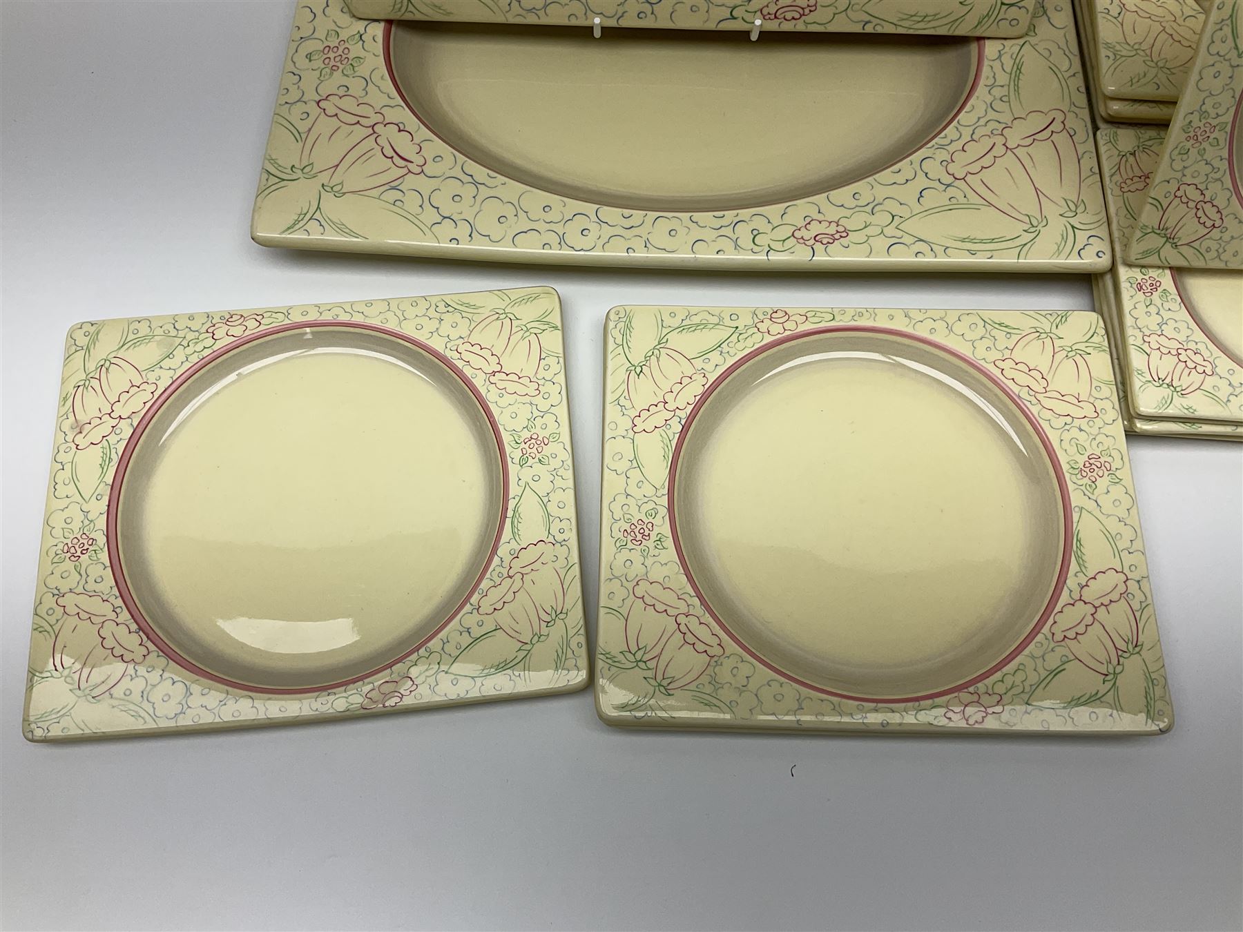 Clarice Cliff Biarritz part dinner set, circa 1930, for Royal Staffordshire, of rectangular form, decorated with bluebells, to include one serving plate, six dinner plates, three side plates, etc, printed mark beneath with reg no 784849 (17)