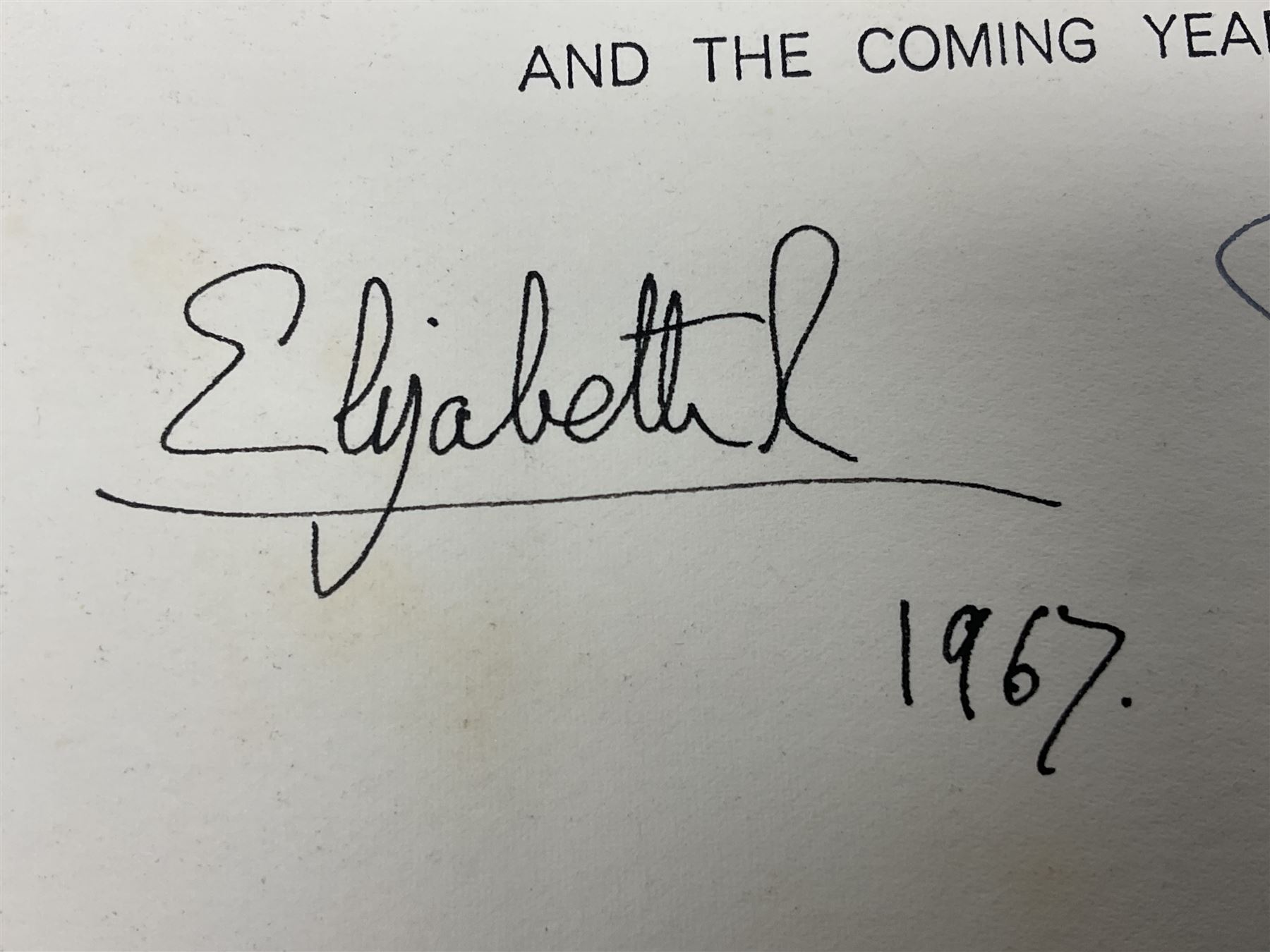 HM Queen Elizabeth II and HRH the Duke of Edinburgh, 1967 Christmas card with two gilt cyphers to front, tipped-in colour print of the Royal Family standing under an archway in Buckingham Palace, signed Elizabeth R and Philip with manuscript date 1967 below