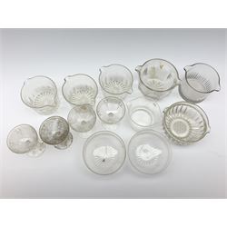 Seven 19th century and later double lip glass rinsers of various design, together with a pair of Edwardian cut glass finger bowls, and four Edwardian champagne glasses with engraved decoration. 