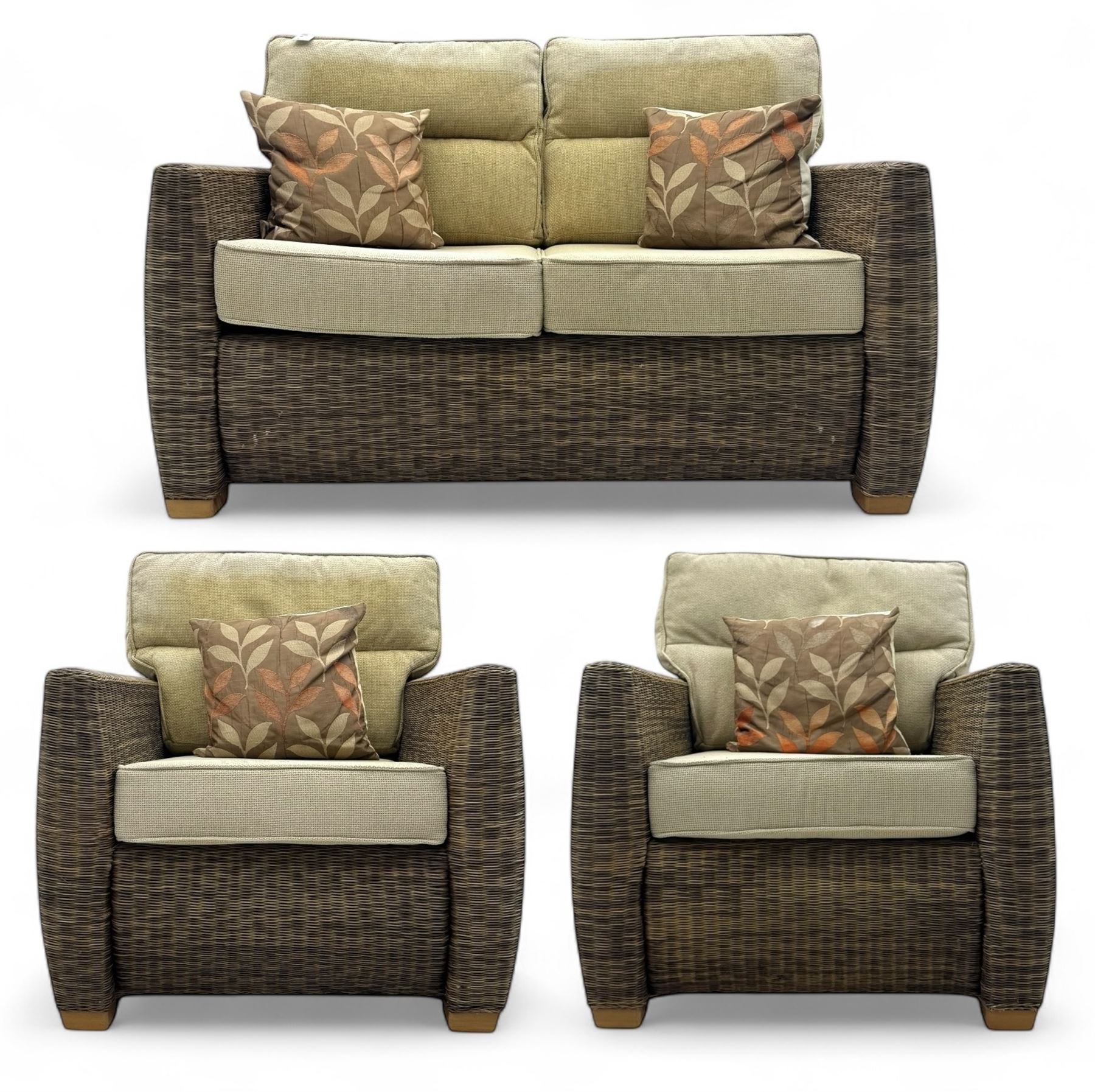 Contemporary two seat rattan conservatory sofa with loose cushions, and pair of matching armchairs, with upholstered seat and back cushions in a beige fabric, curved arms and front complete with scatter cushions 

Chairs (H 92cm, W 75cm, D 84cm)
Sofa (H 92cm, W 130cm, D 84cm)