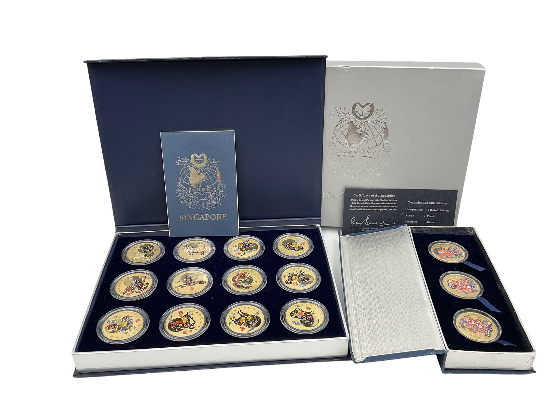 Singapore Venhonia commemorative medallion collection and a Tiger Beer commemorative three-medallion collection, both cased with certificates