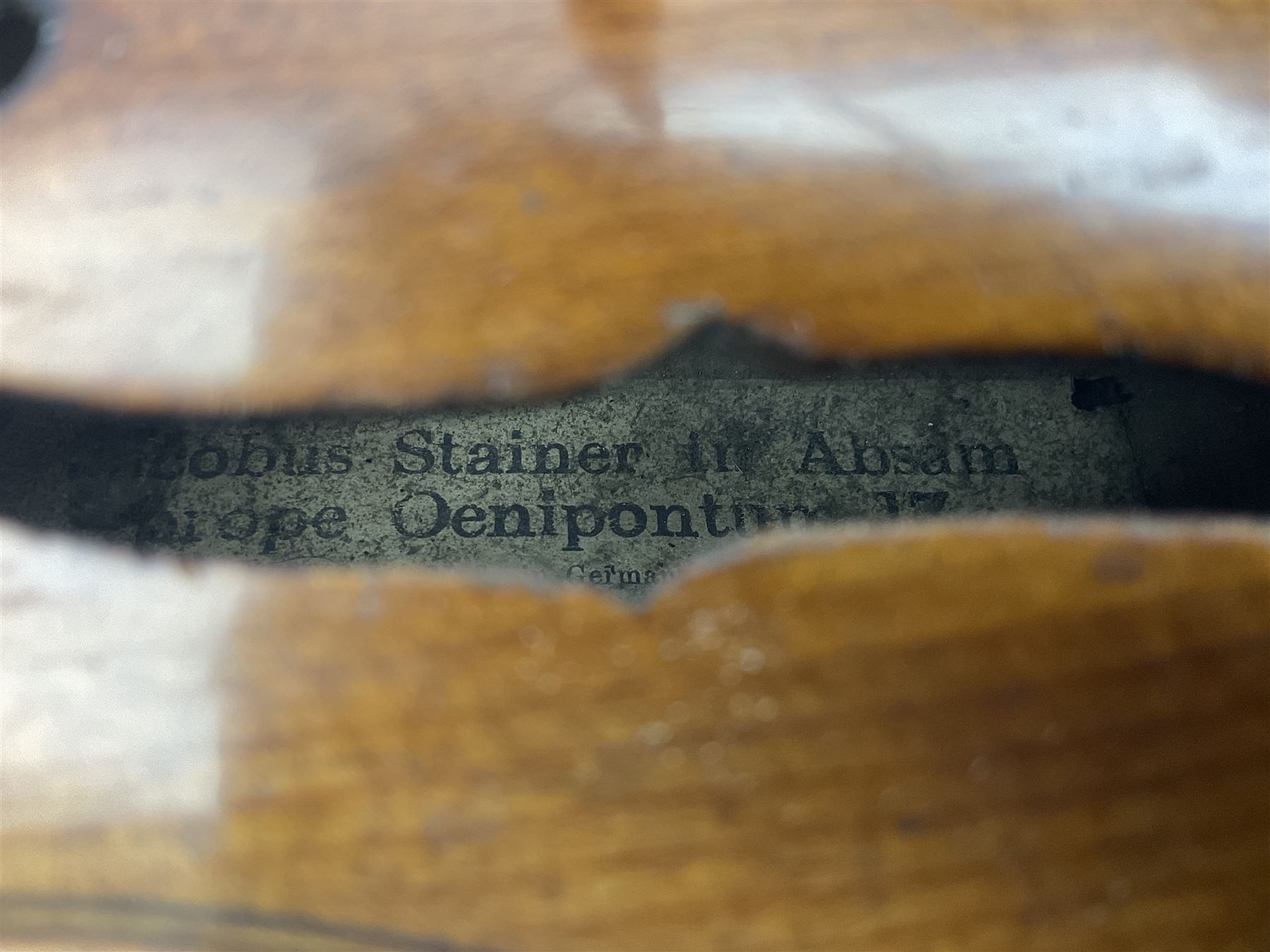 German Saxony violin c1900 with 35.5cm two-piece medium grain maple back and ribs and medium grain spruce top; bears label 'Jacobus Stainer in Absam prope Oenipontum 17xx Made in Germany', 59.5cm overall; with modern bow (2)