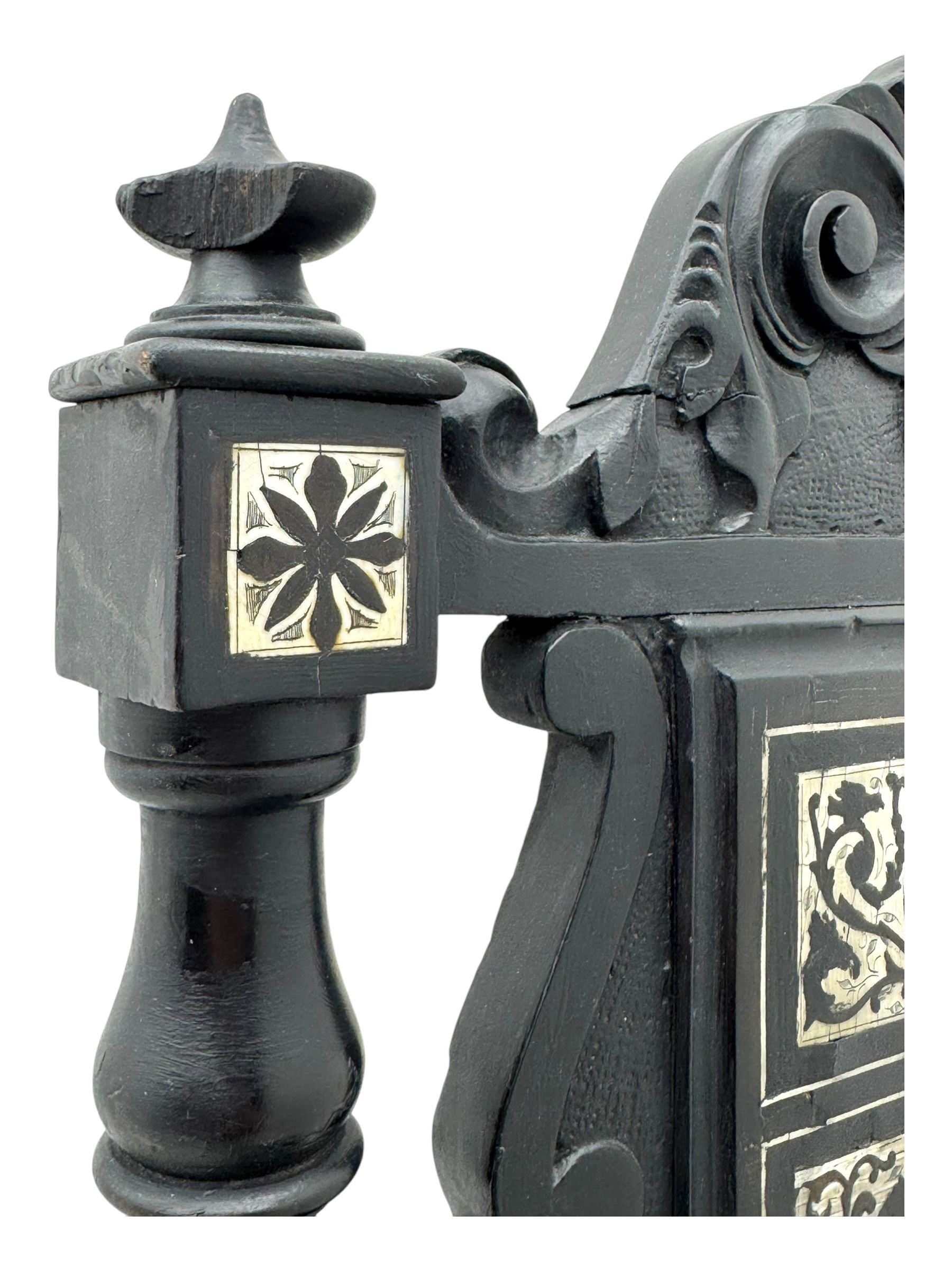19th century Italian ebonised side chair, the backrest inlaid with bone and decorated with a painted figure in Renaissance dress within an arched reserve, flanked by turned supports and scrolled cresting, the seat and frieze similarly inlaid, raised on turned legs with shaped stretchers