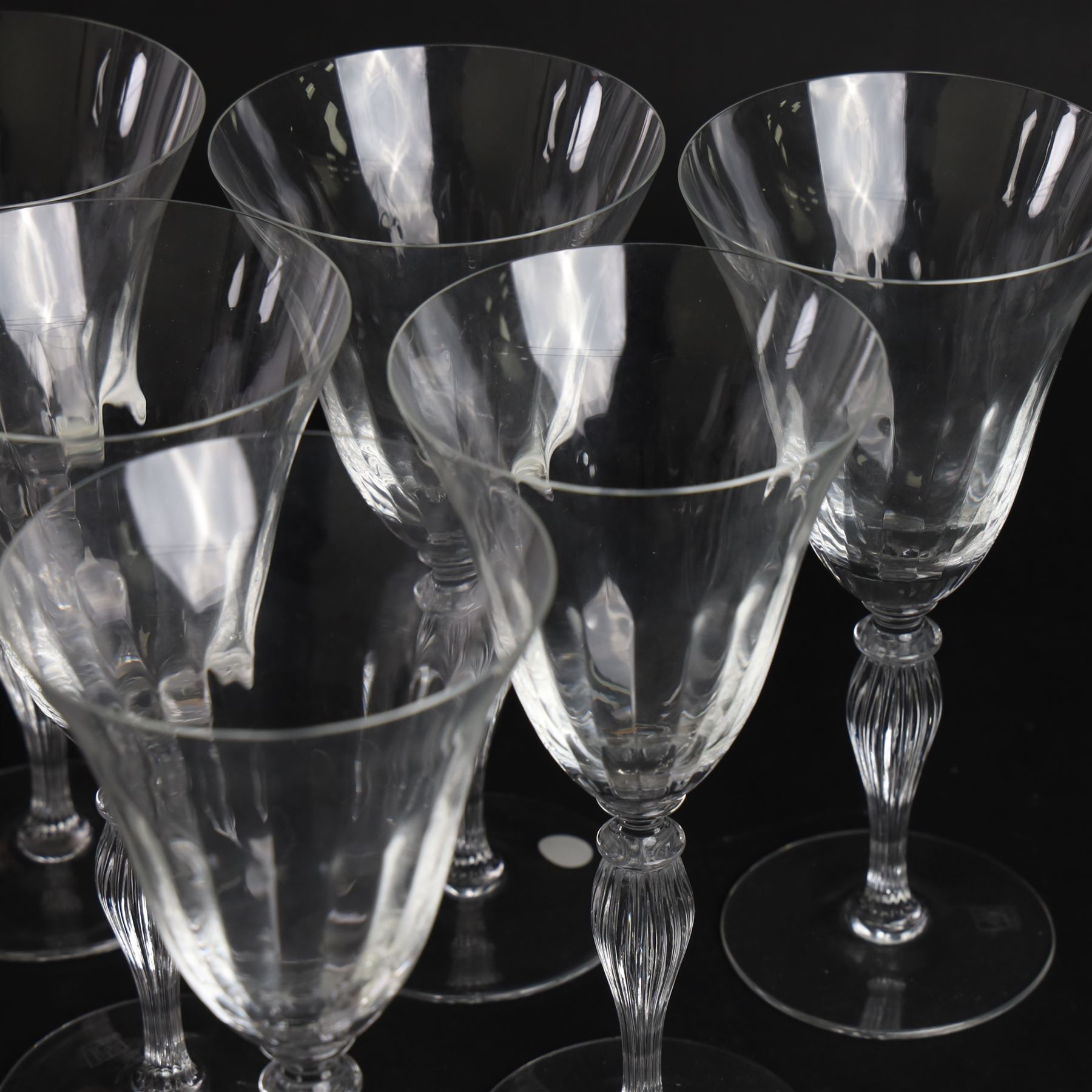 Set of six Murano clear glass wine glasses, each with part moulded fluted flared bowl, upon a knopped and fluted baluster stem and spreading circular foot, with etched marks beneath, H19.5cm
