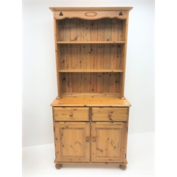  Pine two drawer dresser, two tier rack above two drawers and two cupboards, bun feet (W90cm, H189cm, D44cm) and matching two door cupboard (W90cm, H73cm, D46cm) (2)  