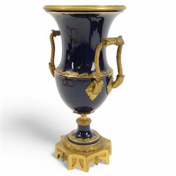 19th century Sevres style ormolu mounted porcelain twin handled urn, the body decorated with a gilt crowned crest of three fleur de lis against a cobalt ground, with spurious Sevres mark beneath, H26cm
