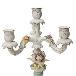 Pair of German porcelain three branch candelabra, the based modelled with putti holding flowers, printed blue mark to base, H35cm (2)