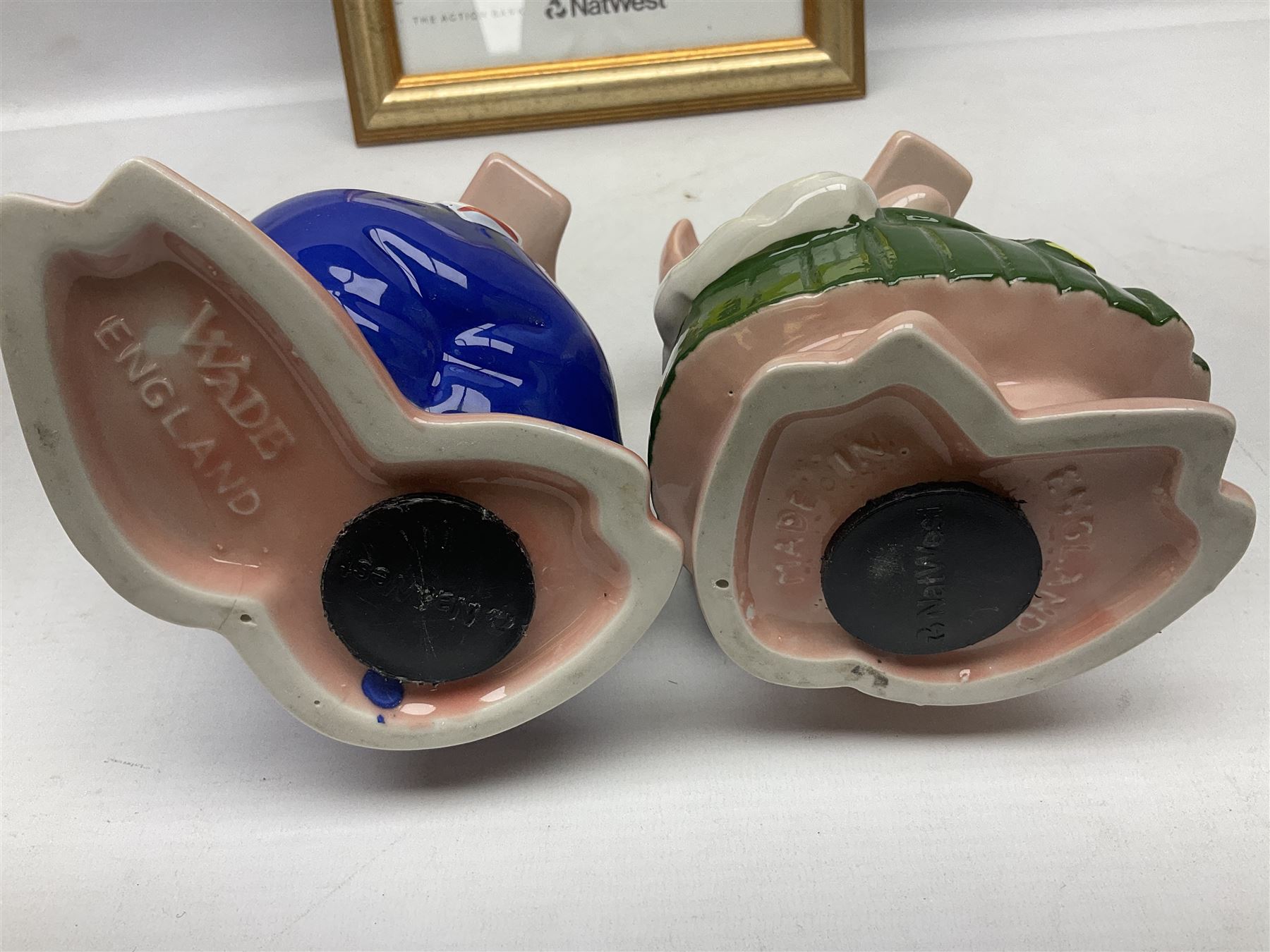  Full Set of Wade Natwest Pigs to include cousin Wesley, with an additional baby and framed leaflet 