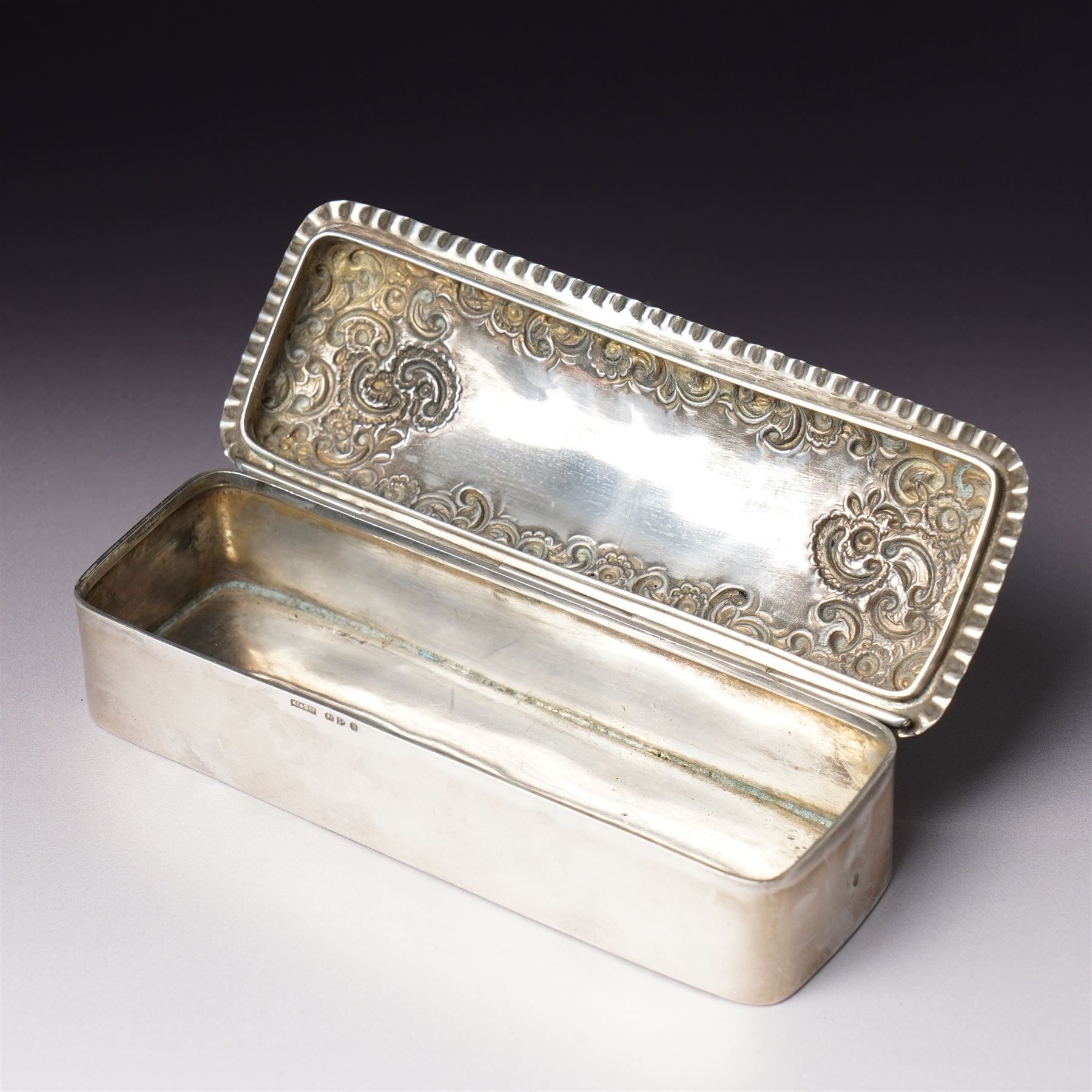 Late Victorian silver dressing table box of rectangular form with embossed hinged lid and engraved with a monogram with crimped border W15.5cm Chester 1896 Maker King & Sons