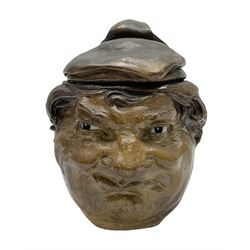 Rare early 20th century Martin Brothers stoneware tobacco jar and cover designed by Robert Wallace Martin, modelled in relief as a smirking face to one side, the other side modelled as the same subject wearing a quizzical expression, the cover formed as a sack hat, incised marks to base 'R W. Martin London & Southall. 10.1.1910', and to inner rim of cover 'R. W. Martin. & Bros London & Southall. 10.1.1910', H18cm

Cf. Waddington's Canada Lot 51 A Private Collection of Martin Brothers Stoneware 06/12/2017
Woolley & Wallace Lot 37 British Art Pottery 01/12/2010