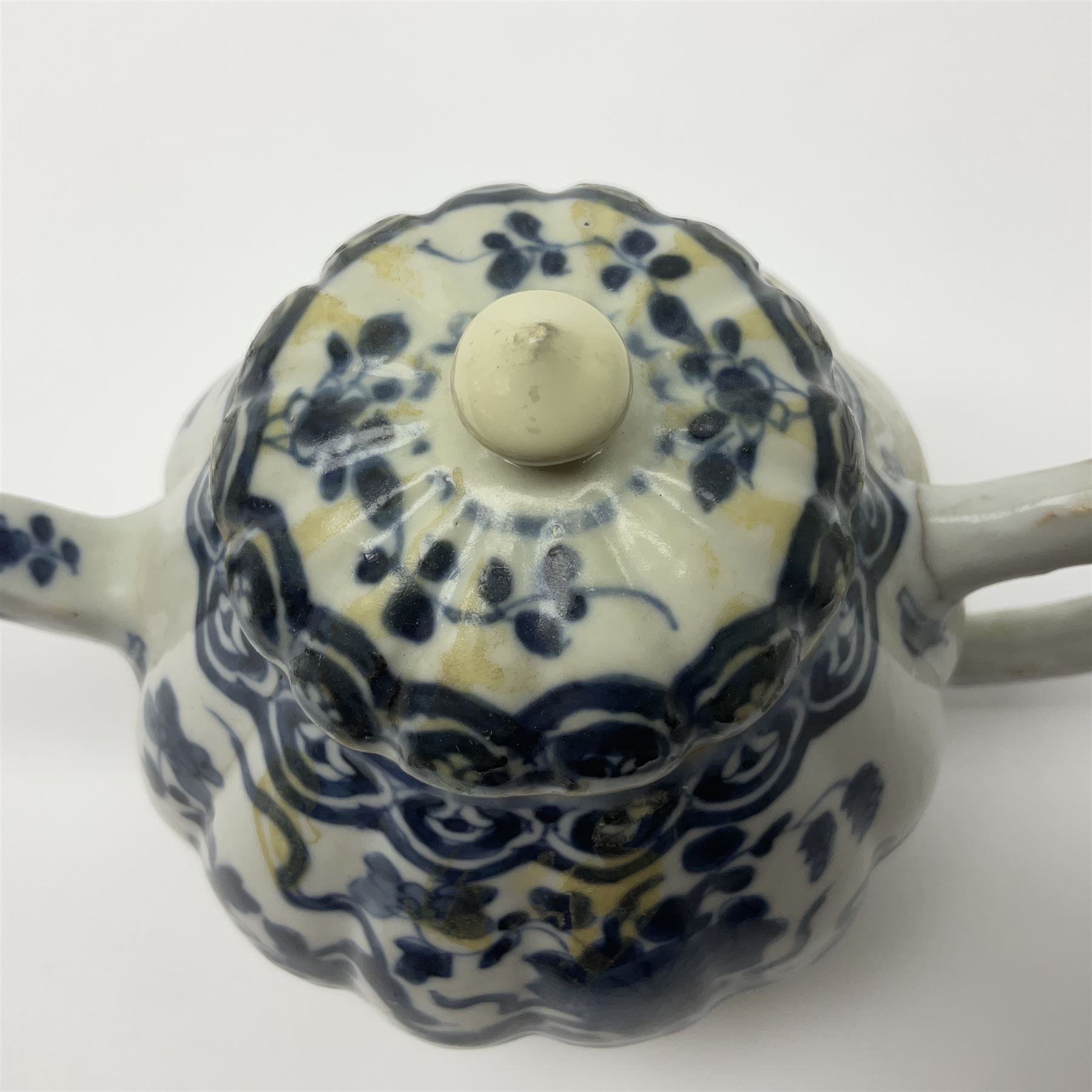 18th century Chinese blue and white teapot, painted with floral sprays, with lobed body and cover, H11cm